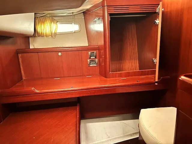 Slide: The Image of Interior of 2007 Beneteau Oceanis 46 yacht with wooden cabinetry and seating. - 27