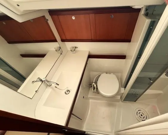 Slide: The Image of Bathroom interior of 2007 Beneteau Oceanis 46 yacht, featuring sink, toilet, and shower. - 28