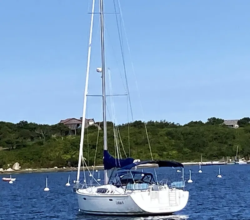 Slide: The Image of 2007 Beneteau Oceanis 46 sailboat anchored in a scenic bay. - 3
