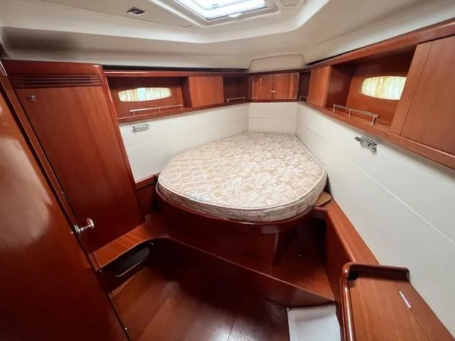 Slide: The Image of 2007 Beneteau Oceanis 46 cabin with wooden interior and cozy bed. - 30