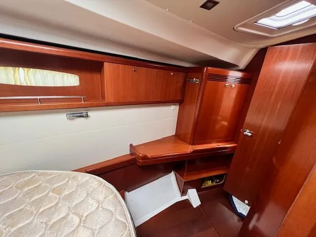 Slide: The Image of Interior cabin of 2007 Beneteau Oceanis 46 yacht with wooden furnishings and storage. - 31