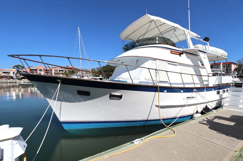 Slide: The Image of 1985 DeFever 44 Trawler docked at marina under clear blue sky. - 12