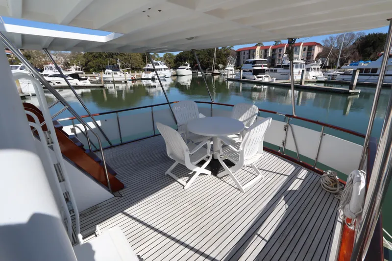 Slide: The Image of 1985 DeFever 44 Trawler deck with seating, docked in a marina. - 13