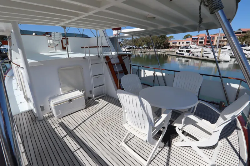 Slide: The Image of 1985 DeFever 44 Trawler deck with seating area, overlooking marina. - 14