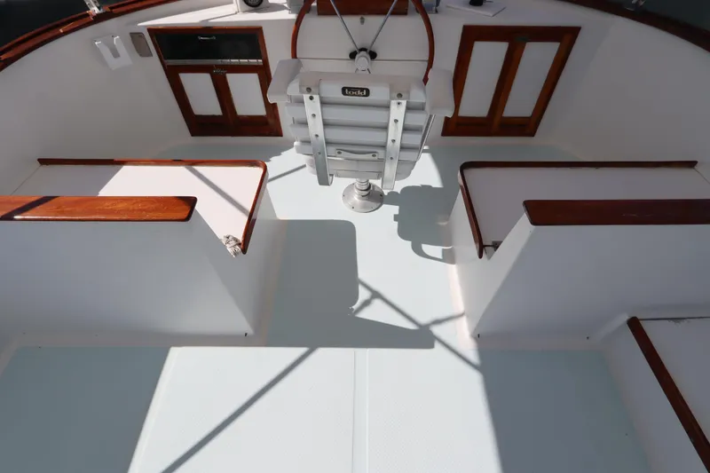 Slide: The Image of 1985 DeFever 44 Trawler cockpit with wooden accents and steering wheel. - 22