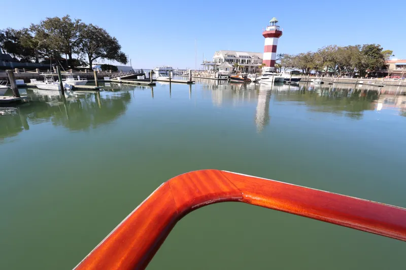 Slide: The Image of View from 1985 DeFever 44 Trawler, overlooking marina with lighthouse and calm waters. - 24