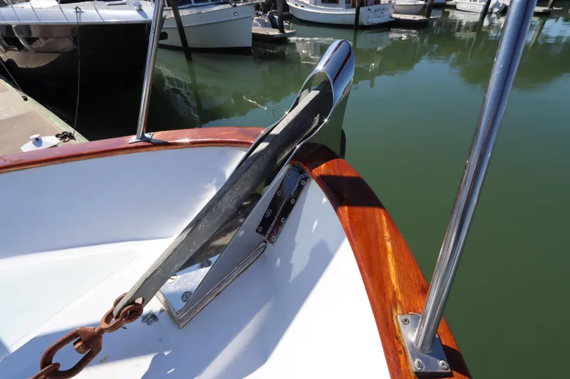 Slide: The Image of DeFever 44 Trawler 1985 anchor detail at marina, showcasing polished wood and metalwork. - 26