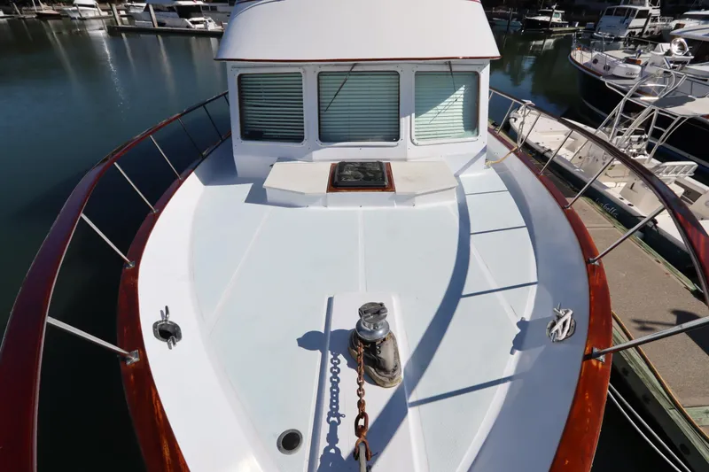 Slide: The Image of 1985 DeFever 44 Trawler boat deck with railing, docked in marina. - 28