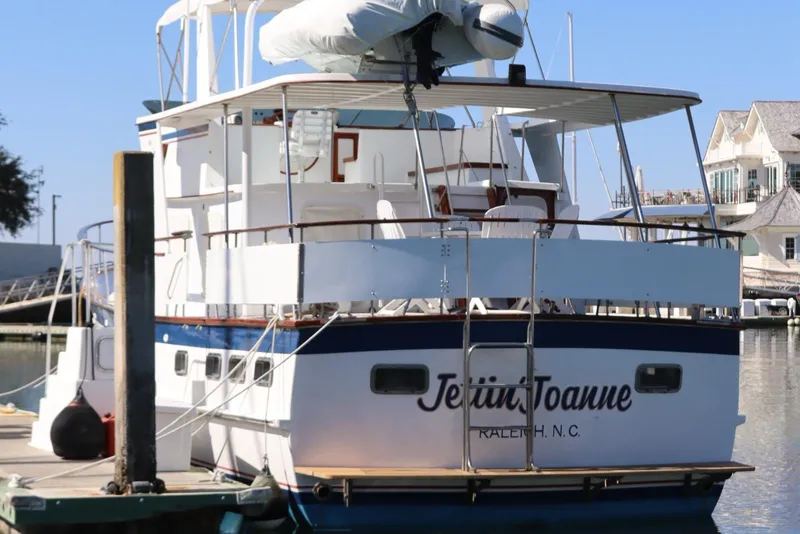 Slide: The Image of 1985 DeFever 44 Trawler docked, named "Jetina Joanne," in a marina setting. - 3