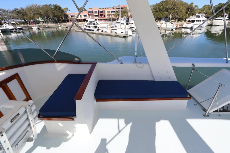 Slide: The Image of 1985 DeFever 44 Trawler deck with blue seating, overlooking marina. - 31