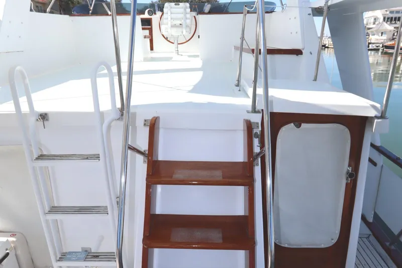 Slide: The Image of 1985 DeFever 44 Trawler deck with wooden steps and white railing. - 37