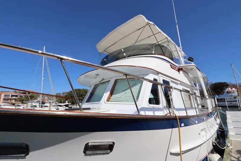 Slide: The Image of 1985 DeFever 44 Trawler docked under clear blue sky. - 4