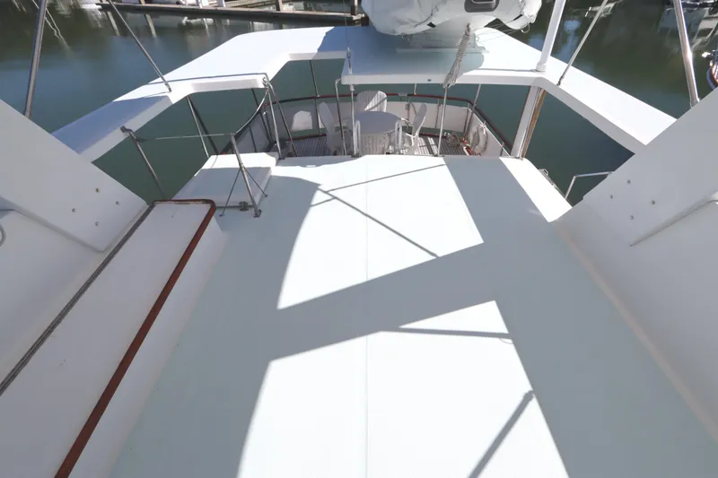 Slide: The Image of 1985 DeFever 44 Trawler deck view, showcasing spacious outdoor area and railing. - 40