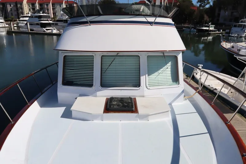 Slide: The Image of 1985 DeFever 44 Trawler boat docked at marina, front deck view. - 45