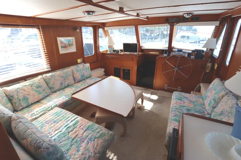 Slide: The Image of Interior of 1985 DeFever 44 Trawler with cozy seating and nautical decor. - 48