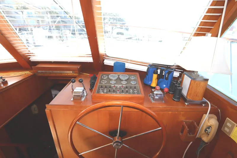 Slide: The Image of 1985 DeFever 44 Trawler helm with wooden wheel and control panel. - 49