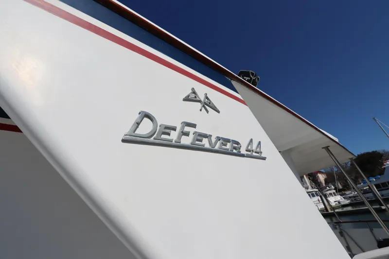 Slide: The Image of 1985 DeFever 44 Trawler boat nameplate against clear blue sky. - 7