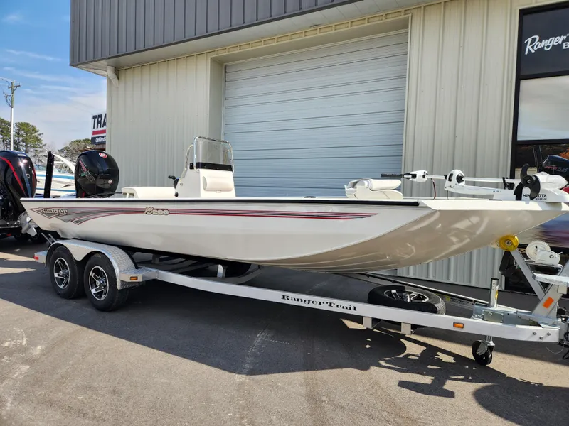 Slide: The Image of 2025 Ranger RB200 boat on trailer, parked outside a building. - 1