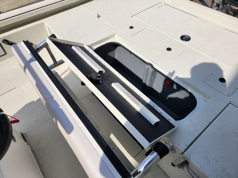 Slide: The Image of 2025 Ranger RB200 boat storage compartment with open lid and seating area. - 13
