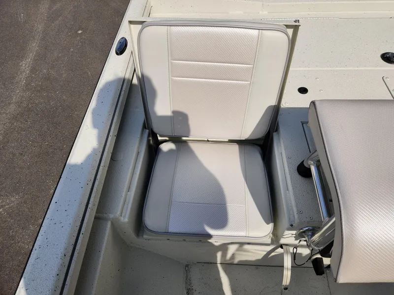 Slide: The Image of 2025 Ranger RB200 boat seat, white upholstery, shadow cast, outdoor setting. - 15