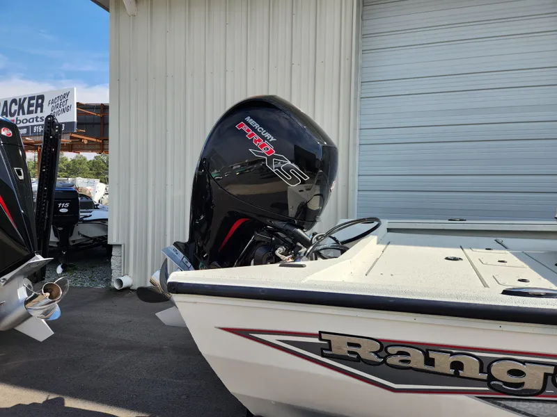 Slide: The Image of 2025 Ranger RB200 boat with Mercury Pro XS engine, parked near a garage. - 3