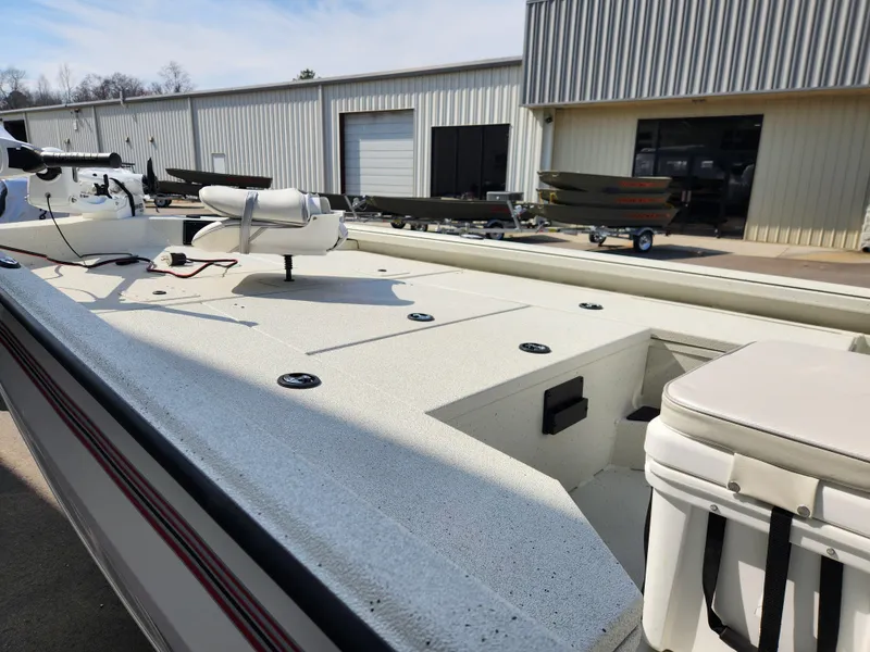 Slide: The Image of 2025 Ranger RB200 boat with spacious deck, parked outside a metal building. - 4