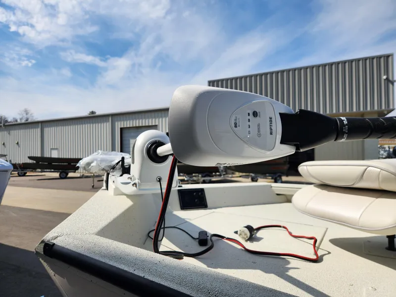 Slide: The Image of 2025 Ranger RB200 boat with motor, parked outdoors under a clear sky. - 8