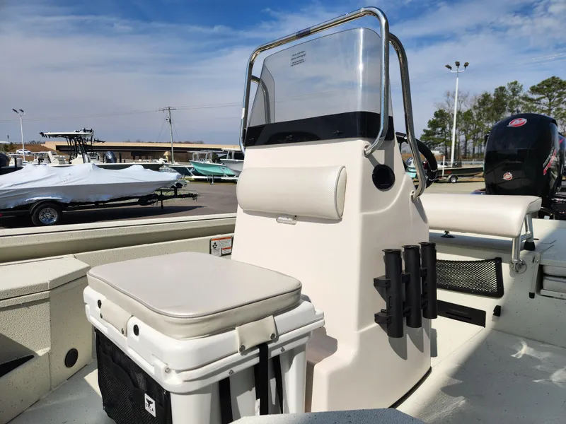 Slide: The Image of 2025 Ranger RB200 boat interior with seating and console, parked outdoors under a clear sky. - 9