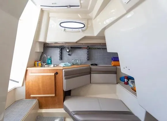 Slide: The Image of Interior cabin of 2025 Solara 250 Center Walkaround boat, featuring seating and storage. - 10