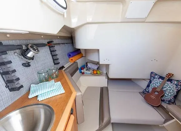 Slide: The Image of 2025 Solara 250 Center Walkaround cabin with seating, sink, and guitar. - 11