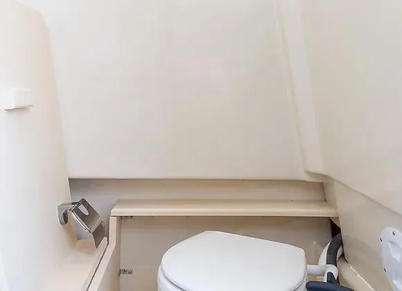 Slide: The Image of 2025 Solara 250 Center Walkaround boat interior with compact marine toilet. - 8