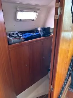 Slide: The Image of Interior cabin of a 2005 Hunter 33 sailboat with wooden cabinetry and storage. - 13