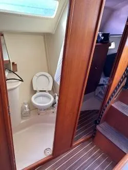 Slide: The Image of 2005 Hunter 33 yacht interior with bathroom and wooden stairs. - 14