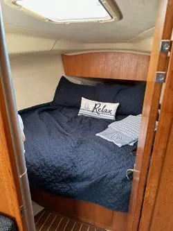 Slide: The Image of Cozy cabin interior of 2005 Hunter 33 sailboat with comfortable bedding. - 15