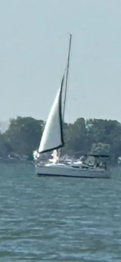 Slide: The Image of Sailboat on water, Hunter 33 model, 2005, with trees in the background. - 3