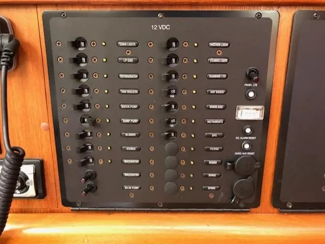 Slide: The Image of Control panel of a 2005 Hunter 33 boat, featuring various switches and indicators. - 6