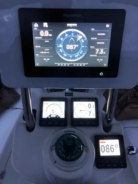 Slide: The Image of Sailboat navigation instruments on a 2005 Hunter 33, featuring digital displays and compass. - 7
