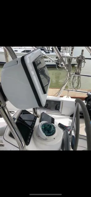 Slide: The Image of 2005 Hunter 33 sailboat cockpit with navigation equipment and steering wheel. - 8