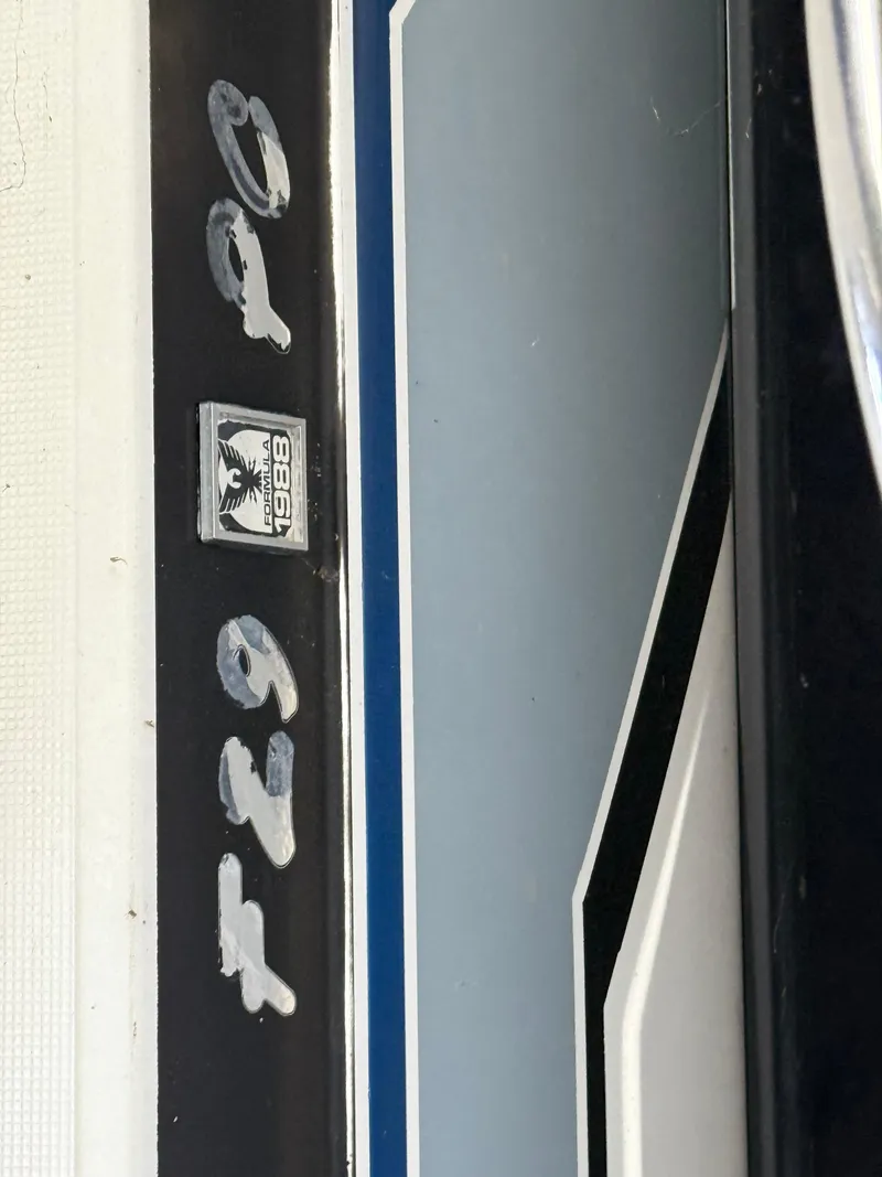 Slide: The Image of 1988 Formula 29 PC boat emblem with blue and black design elements. - 10