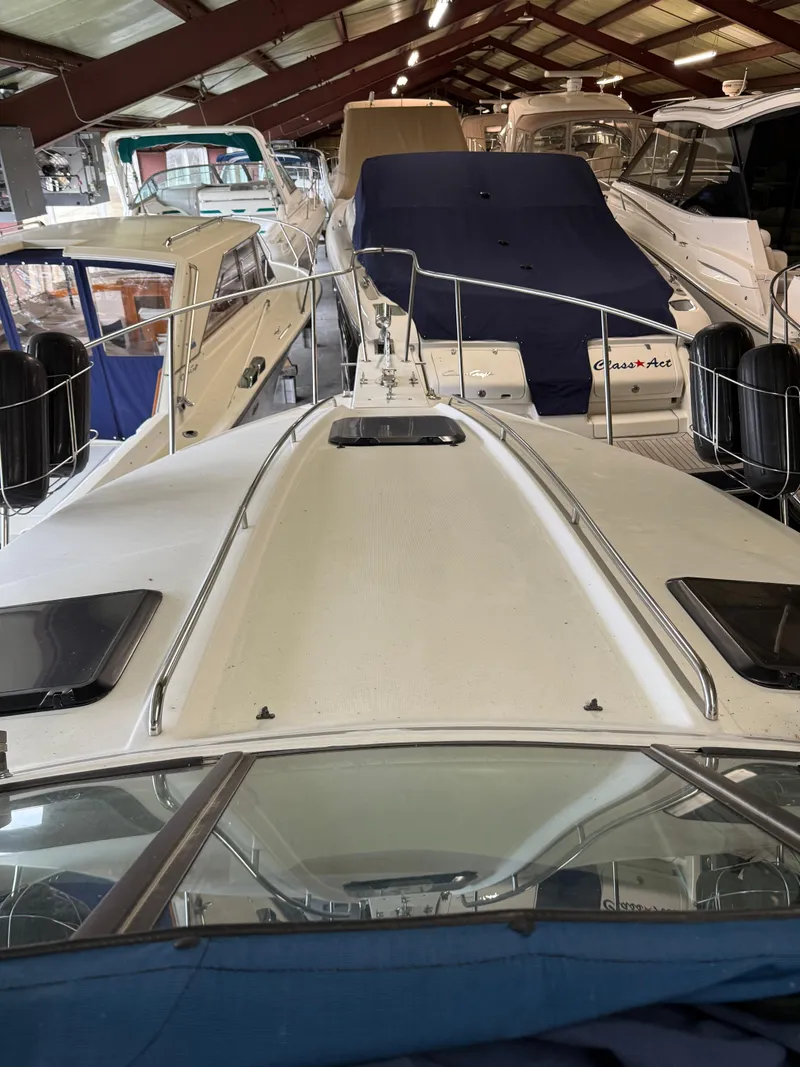 Slide: The Image of 1988 Formula 29 PC boat in storage, surrounded by other vessels. - 11