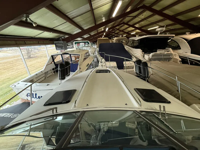 Slide: The Image of 1988 Formula 29 PC boat in indoor storage, surrounded by other vessels. - 12