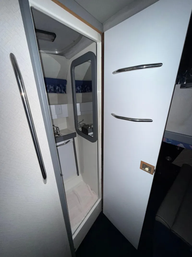 Slide: The Image of 1988 Formula 29 PC boat interior with compact bathroom and mirror. - 15