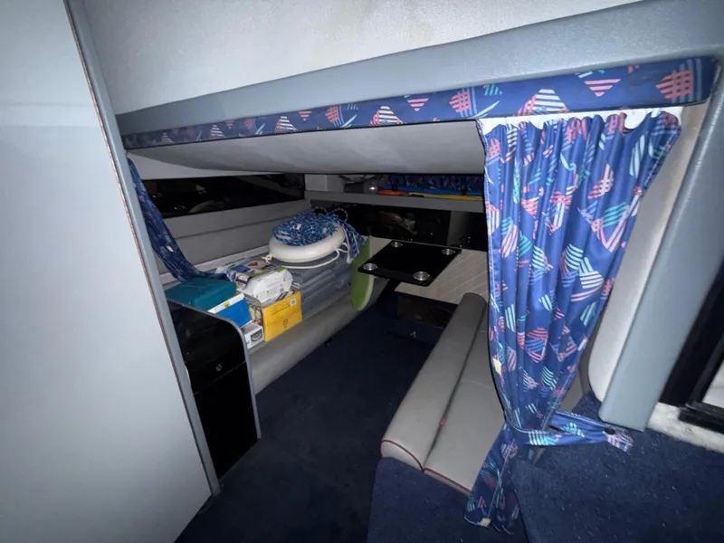 Slide: The Image of Interior of 1988 Formula 29 PC boat with seating and patterned curtains. - 16