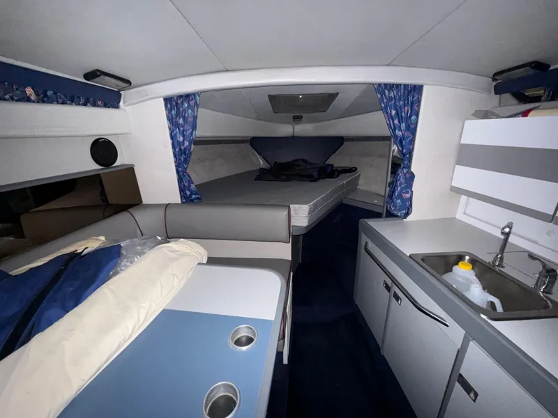 Slide: The Image of 1988 Formula 29 PC cabin interior with bed, kitchenette, and seating area. - 21