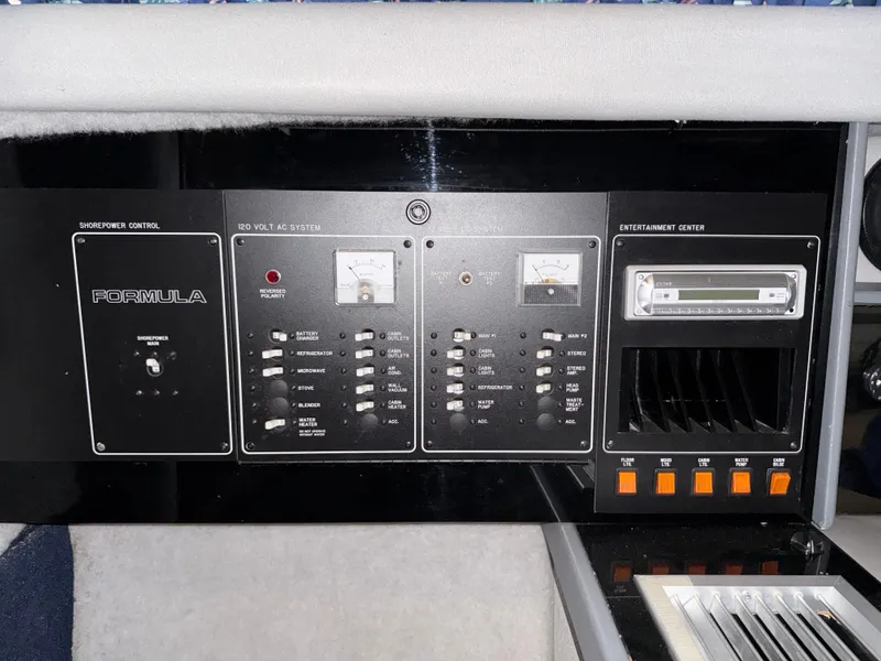 Slide: The Image of Control panel of a 1988 Formula 29 PC boat, featuring switches and meters. - 23
