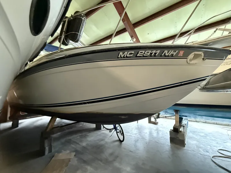 Slide: The Image of 1988 Formula 29 PC boat in storage, side view with registration number visible. - 36