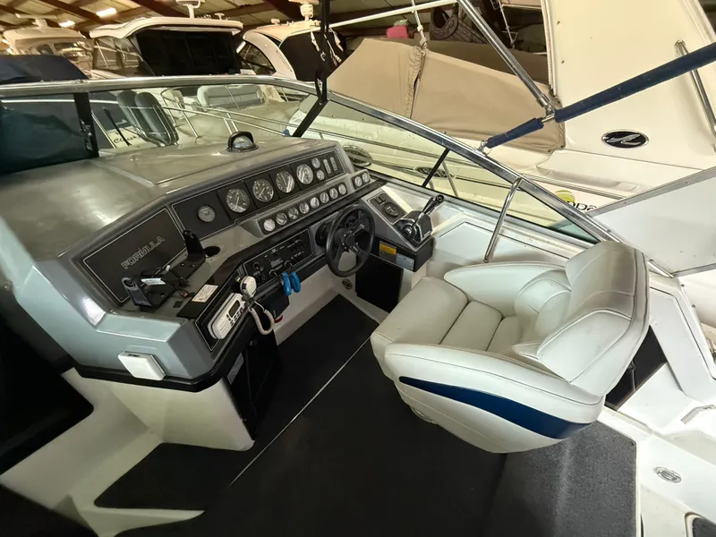 Slide: The Image of 1988 Formula 29 PC boat cockpit with steering wheel and control panel. - 37