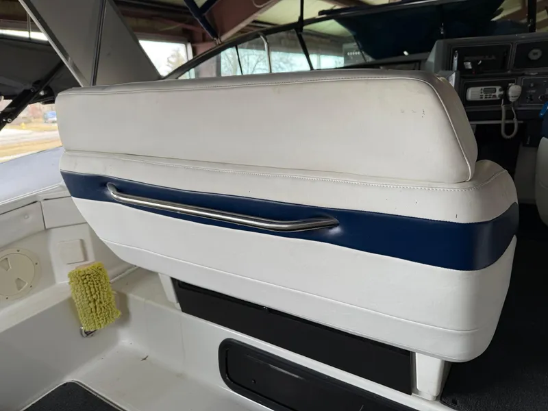 Slide: The Image of 1988 Formula 29 PC boat interior with white seating and blue accents. - 38