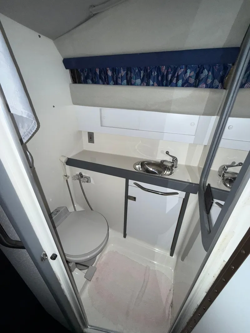 Slide: The Image of 1988 Formula 29 PC boat bathroom with sink, toilet, and compact design. - 39