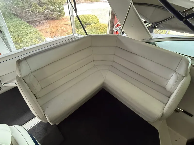 Slide: The Image of 1988 Formula 29 PC boat interior with white cushioned seating. - 41